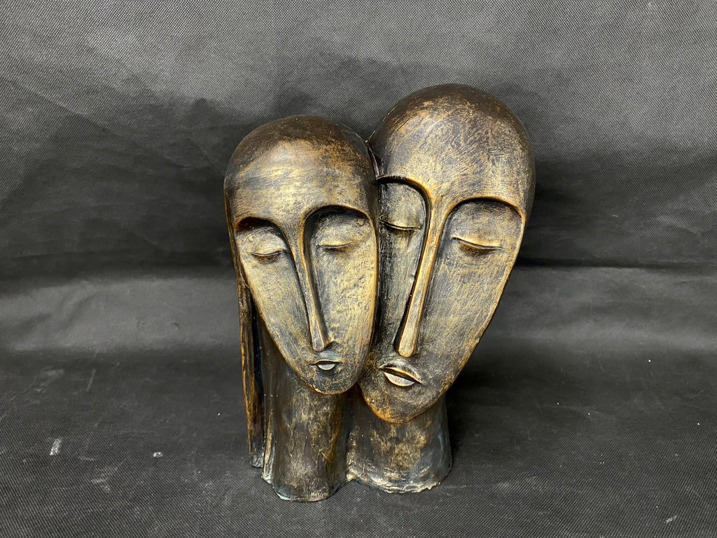 Escultura de cabezas negro/oro